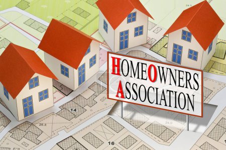 Homeowner Association concept with residential homes models against an imaginary city map and text