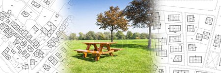 Photo for Wooden picnic table on a green meadow of a public park with trees against an imaginary city map with recreation areas, green spaces for leisure activities and municipal services - Royalty Free Image
