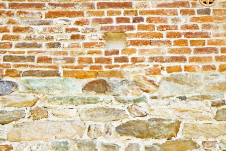 Photo for Old medieval italian stone and brick wall, built with splitted blocks, recently restored - Royalty Free Image