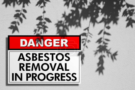 Photo for Asbestos Removal warning sign concept - Hazard Management with placard against a wall - Royalty Free Image
