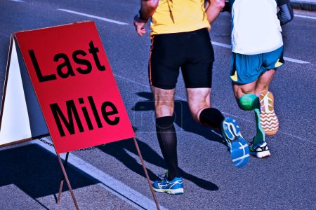 Two runners are running the last mile with text over a road sign