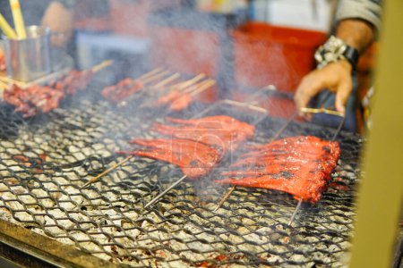 Photo for Grilled seafood with smoke, Malaysian street food at Jalan Alor Market. selective focus and copy space - Royalty Free Image
