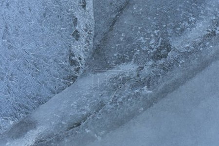 Frosty pattern on a frozen lake in winter, closeup of photo