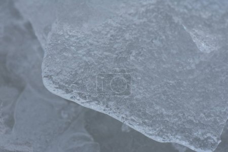 Frosty pattern on a frozen lake in winter, closeup of photo