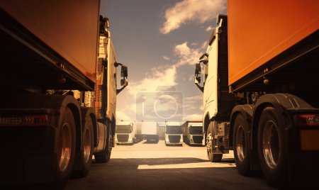 Photo for Semi TrailerTrucks on Parking with The Sky. Shipping Container Diesel Trucks. Trucking. Truck Wheels Tire. Delivery Transit. Lorry Tractor. Industry Freight Trucks Logistics Cargo Transport. - Royalty Free Image