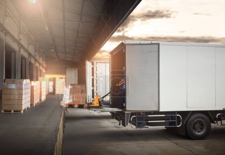 Photo for Warehouse Workers Unloading Cargo Boxes on Pallet into Container Trucks. Distribution Shipping Warehouse. Delivery Trucks. Shipment Goods. Supply Chain. Supplies Warehouse Logistics Transport. - Royalty Free Image