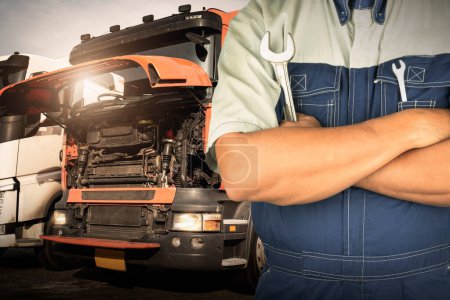 Mechanic Holding A Wrench for Semi Truck Maintenance. Checking the Truck's Safety. Repairman Service Shop. Inspection Safety Driving.