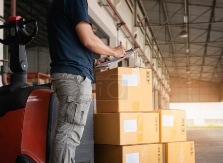 Photo for Workers Holding Clipboard is Checking Package Boxes in Storage Warehouse. Inventory Management Supply Chain. Shipment Boxes. Shipping Warehouse Logistics. - Royalty Free Image