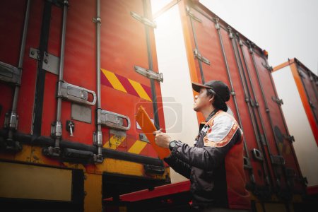 Photo for Truck Driver is Checking Container Door. Security of Cargo Shipping. Semi Truck Maintenance. Inspection Safety Before Driving. Freight Truck Logistics Transport. - Royalty Free Image