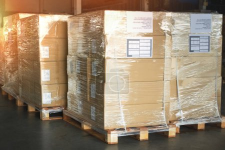Photo for Package Boxes Wrapped Plastic on Pallets in Storage Warehouse. Storehouse Distribution Storage. Supply Chain. Shipping Cargo Supplies Warehouse Logistics. - Royalty Free Image