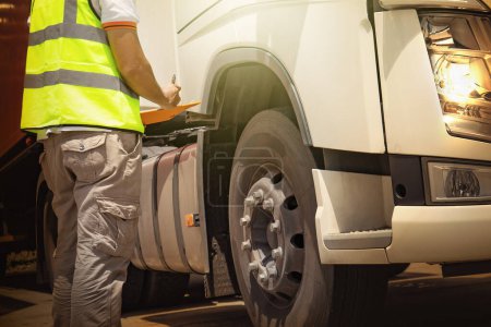 Truck Driver is Checking the Truck's Safety of Truck Wheels Tires. Auto Mechanic. Truck Inspection Safety Driving.