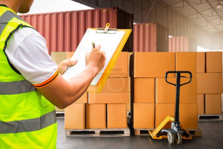 Photo for Worker Holds a Clipboard Checking the Loading Package Boxes at Distribution Warehouse. Delivery Shipment to Customers. Supplies Warehouse, Freight Truck, Warehouse Logistics Transport - Royalty Free Image