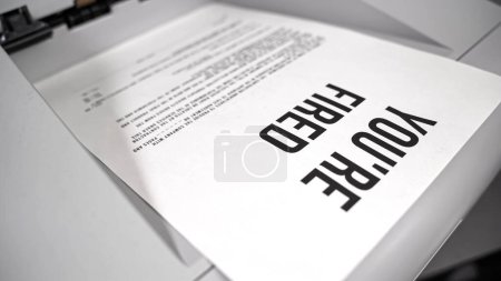 Fax comes message Youre fired. Concept of unemployment, layoffs, bankruptcy. High quality photo
