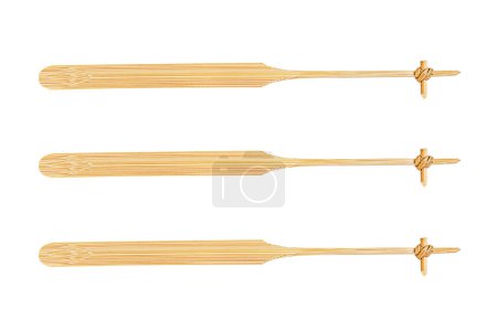 It is Three bamboo stirrers isolated on white background.