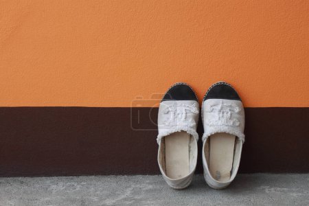 it is sneaker on painted cement wall.