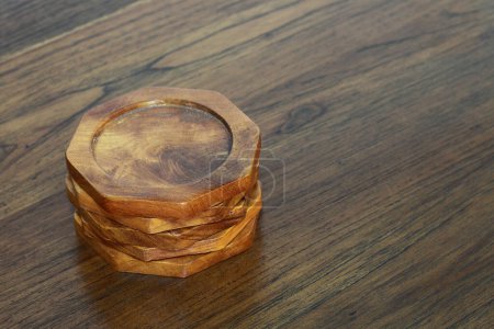 it is wooden coasters on wooden table.