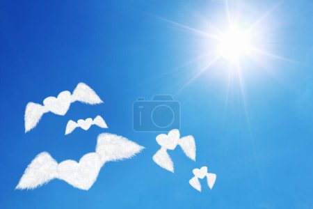 it is group of flying heart shaped clouds under sun shines.