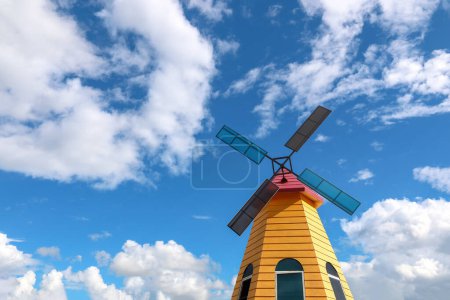 it is colorful windmill with blue sky background.