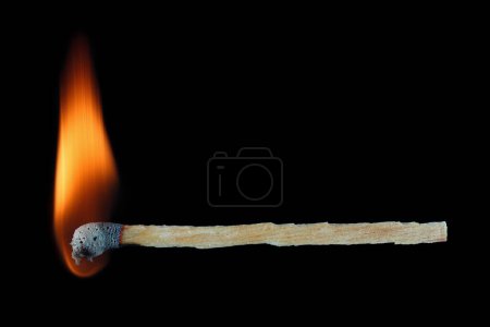 It is Burning match stick isolated on black.