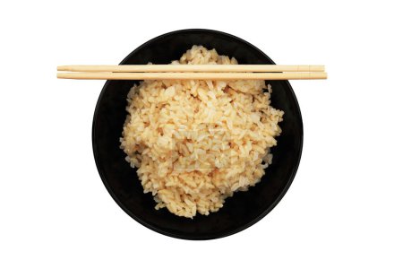 Téléchargez les photos : Steamed healthy unpolished brown rice in black bowl and chopsticks isolated on white. - en image libre de droit