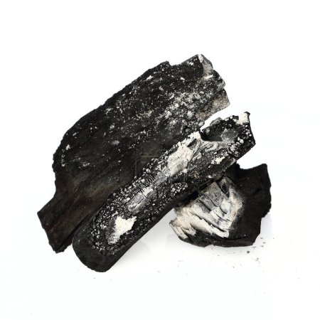 schwarze Kohle mit Asche auf weißem Hintergrund.