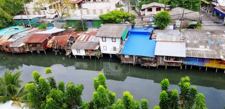 Photo for Many house or home of people living beside the river or lake at countryside in Bangkok, Thailand. Small villages or slums concep - Royalty Free Image
