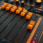 Orange button of sound mixer panel equipment for mixing or control audio system with selective focus technique. Technology, Tool and Digital device concep