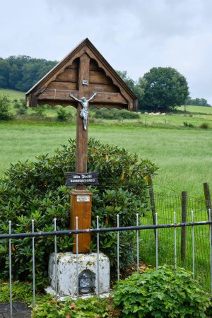 Foto de Cross with Jesus Christ crucified with the text, My Jesus mercy, along road. Limburg, Netherlands.Catholic memorial at intersection of roads and streets. Religious expression Christ died on the cross - Imagen libre de derechos