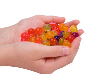 Water coloured gel balls on hand. Isolated on white. Orbeez.