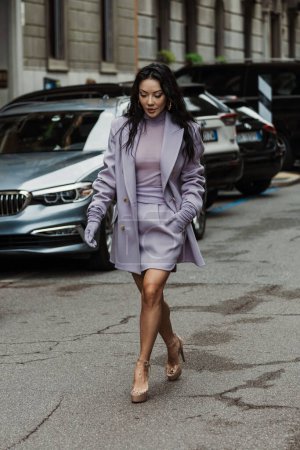 Foto de Jessica Wang vistiendo tacones de vinilo, todo vestido de color lila, visto fuera de MAX MARA espectáculo durante la Semana de la Moda de Milán Womenswear Primavera / Verano 2024. - Imagen libre de derechos