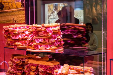 Photo for MALAGA, SPAIN - December 3, 2022: Zorita shop offering spanish traditional meat called 'Hamon' on Marqus de Larios street in Malaga, Spain on December 3, 2022 - Royalty Free Image