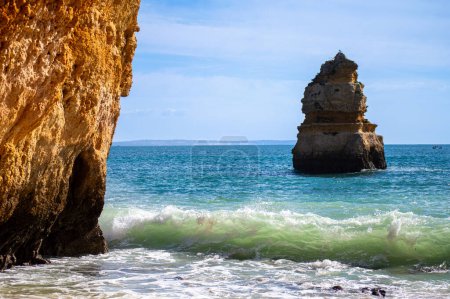 Photo for View of idyllic nature landscape with rocky cliff shore and waves crashing on. Camillo beach in Lagos. West Atlantic coast of Algarve region, south of Portugal. - Royalty Free Image
