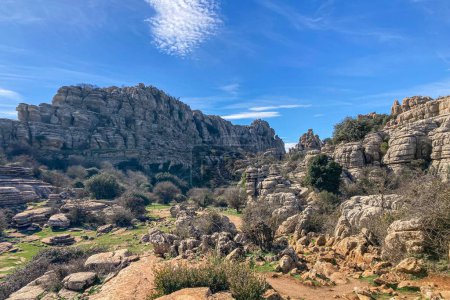 Hiking the Torcal de Antequerra National Park, limestone rock formations and known for unusual karst landforms in Andalusia, Malaga, Spain.