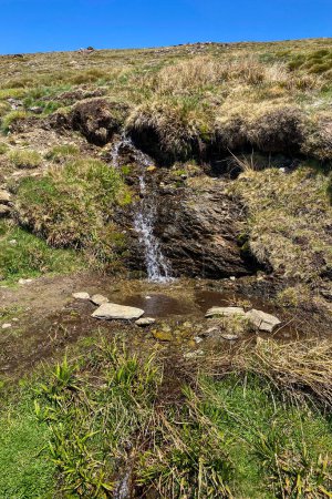 Photo for Water stream flowing from melting snow in the spring, Sierra Nevada range, Andalusia, Spain - Royalty Free Image