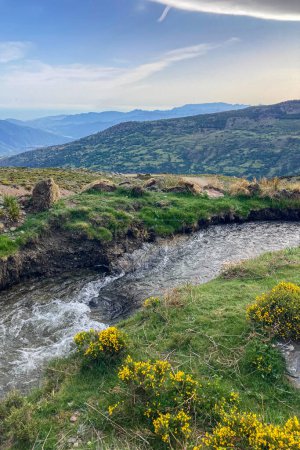 Water stream flowing from melting snow in the spring, Sierra Nevada range, Andalusia, Spain