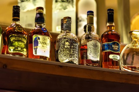 Photo for Stalida, Crete, Greece  06.12.2023. Various bottles of assorted global hard liquor brands including  exclusive rum. Bar and restaurant concept. Selective focus. - Royalty Free Image