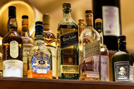 Photo for Stalida, Crete, Greece  06.12.2023.Various bottles of assorted global hard liquor brands including  Scotch whiskey, rum. Bar and restaurant concept. Selective focus. - Royalty Free Image