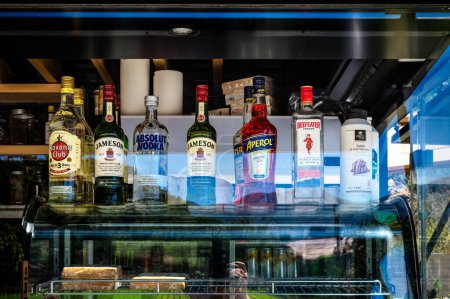 Photo for Various bottles of assorted global hard liquor brands including Scotch whiskey, vodka, aperol, gin. Bar and restaurant concept. Selective focus. - Royalty Free Image