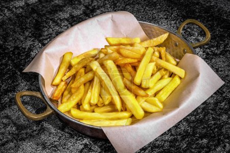 Photo for Close-up of Perfectly Served French Fries in a Stylish Frying Pan.  Ideal for menus, food blogs, or any design endeavor seeking to capture the essence of indulgent comfort food. - Royalty Free Image
