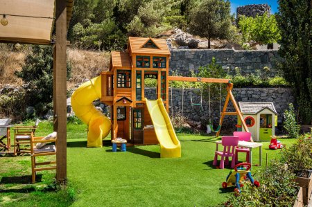 Photo for Playful Moments - Close-Up of Outdoor Standard Children's Playground. The vibrant colors, well-designed structures, and inviting play equipment create an atmosphere of fun and excitement. - Royalty Free Image