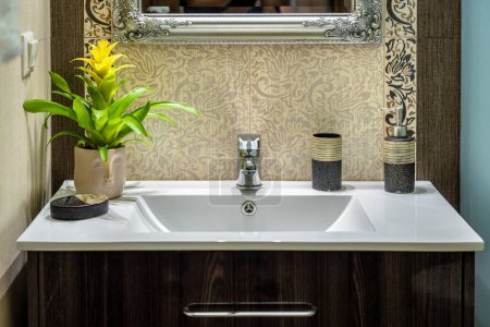Luxurious Bathroom Interior: Close-Up of Elegant White Sink and Detailing. Elevate your visual projects with this image, perfect for illustrating opulent home decor or promoting lavish lifestyle concept