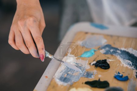 Photo for Hand mix paints in palette in art-class - Royalty Free Image
