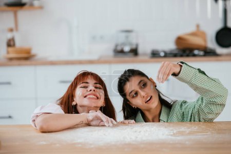 Photo for Women play with flour in the kitchen - Royalty Free Image