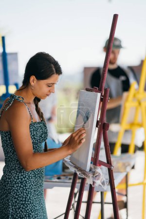Photo for Female artist painting picture in workshop - Royalty Free Image