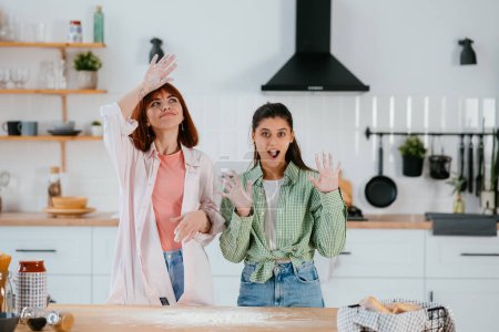 Photo for Women play with flour in the kitchen - Royalty Free Image