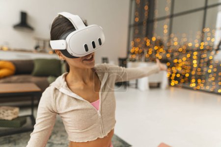 Photo for A trainer offers virtual fitness sessions at home through a virtual reality headset during the Christmas festivities. High quality photo - Royalty Free Image