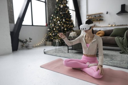 Photo for During the festive season, a trendy young woman is seen in a virtual reality headset. High quality photo - Royalty Free Image