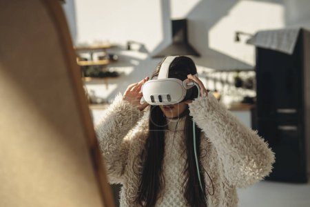 Photo for On a sunny day, a bright young woman experiences virtual reality in front of the mirror. High quality photo - Royalty Free Image