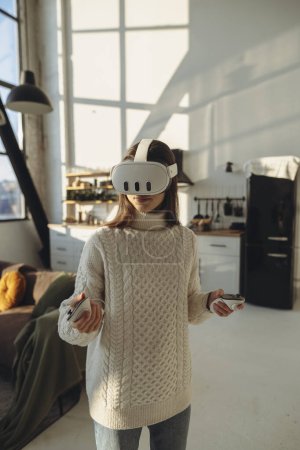 Photo for The beautiful young woman in a VR headset is describing her experiences. High quality photo - Royalty Free Image