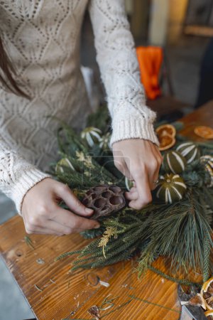 Photo for A young woman takes part in a crafting workshop, making festive Christmas ornaments. High quality photo - Royalty Free Image